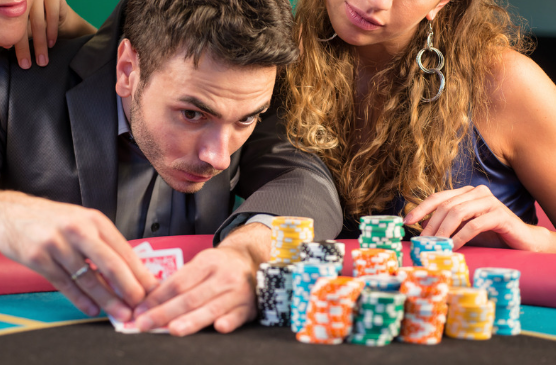 poker player checking cards poker chips